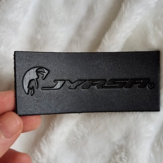 Custom debossed logo on a PU faux leather patch for hats