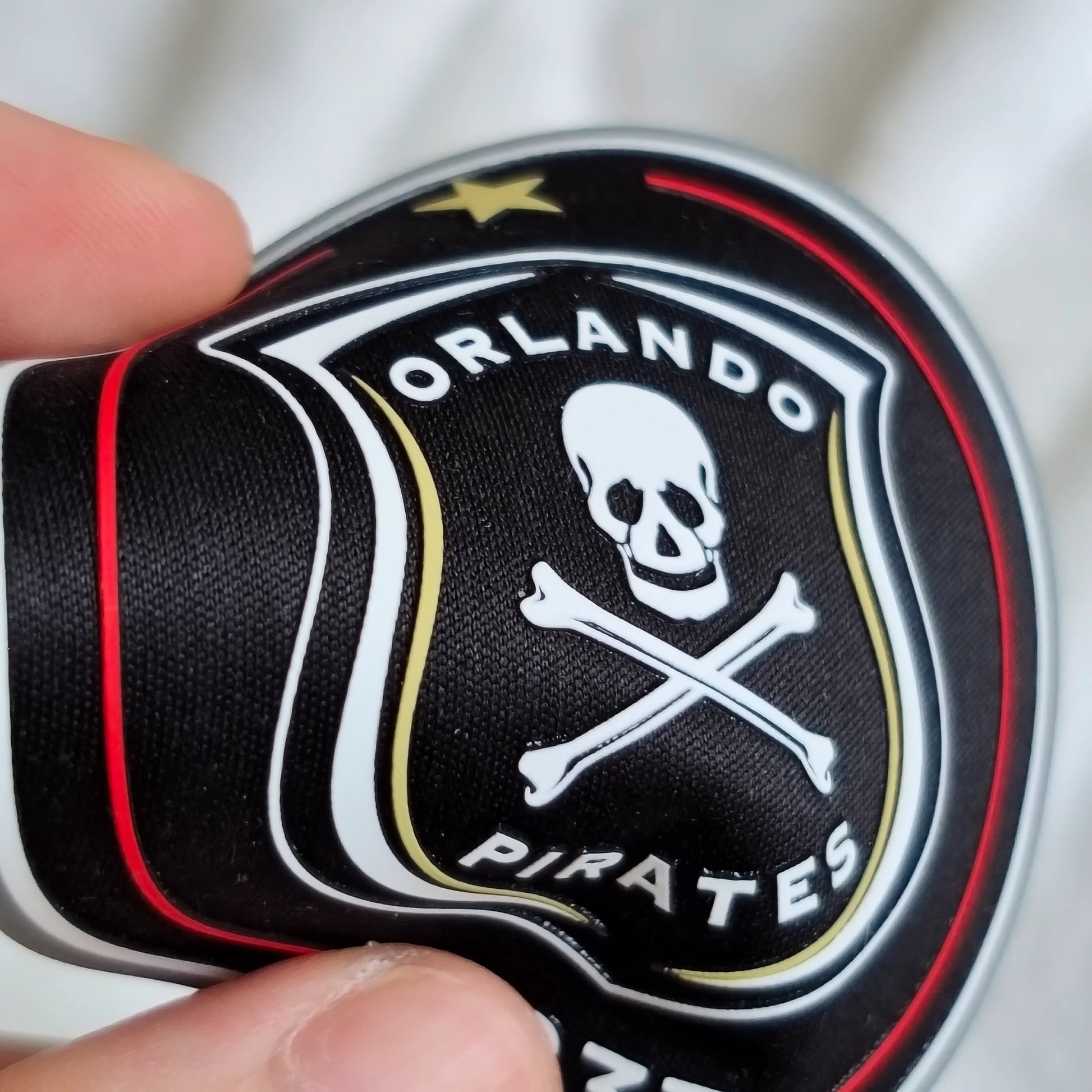 Custom 3D TPU logo on a soft black fabric badge