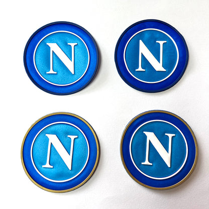 A custom 3D black silicone logo badge with a heat transfer backing, ready to be applied to a jacket